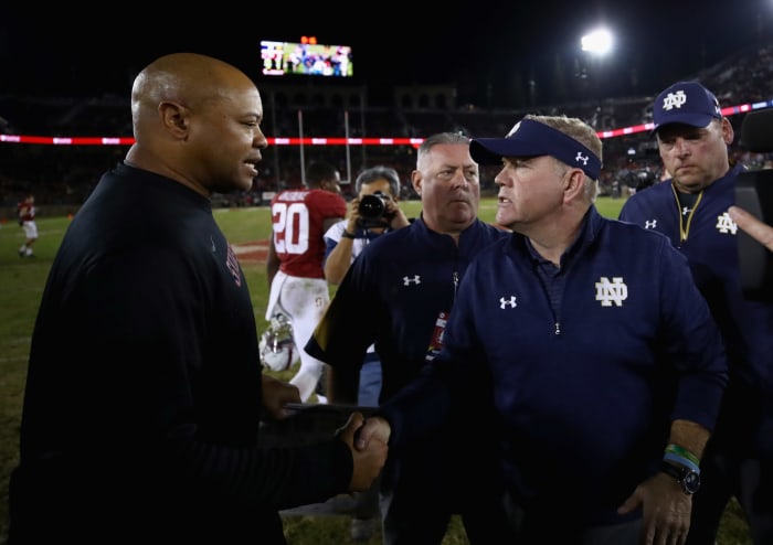 Notre Dame coach Brian Kelly shaking hands with Stanford coach David Shaw after a game.