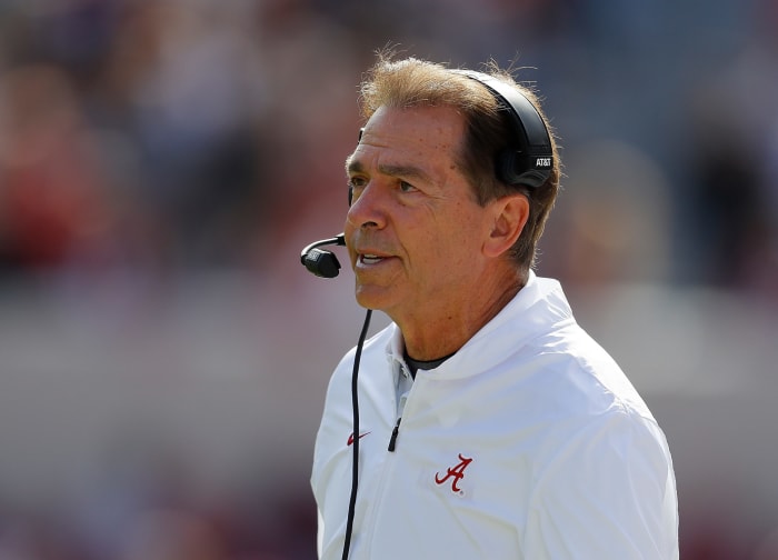 A closeup of Nick Saban wearing a headset.
