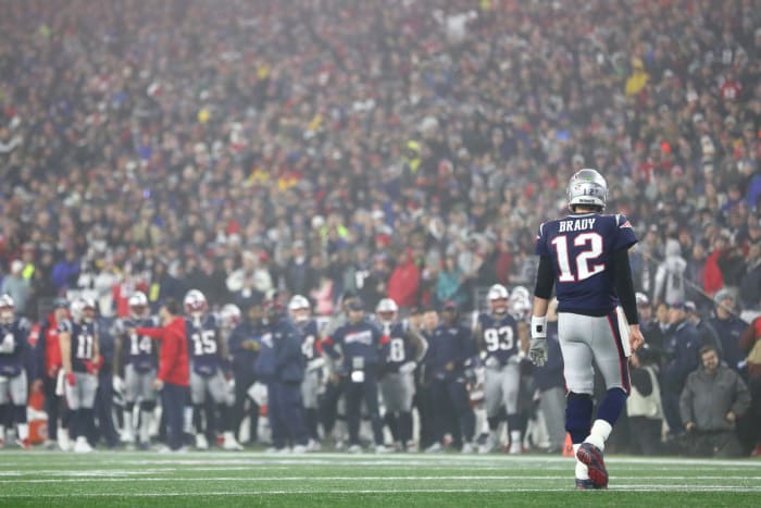 Tom Brady walks off the field in the AFC Wild Card round.