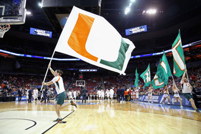 Miami cheerleaders carrying flags
