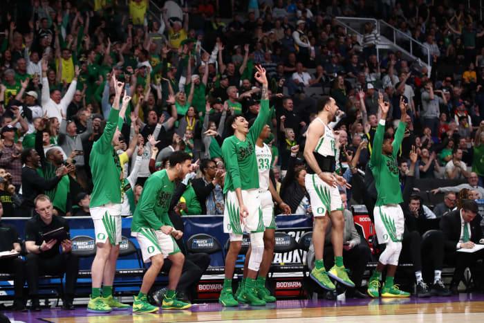 Oregon's bench celebrating during a basketball game.