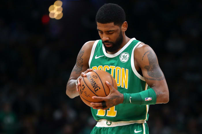 Kyrie Irving observing the ball during a game.