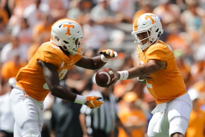 Jarrett Guarantano hands off for Tennessee.