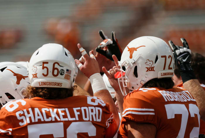 Zach Shackelford and the Texas Longhorns football offense in the huddle.
