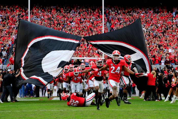 Georgia football players running onto the field.