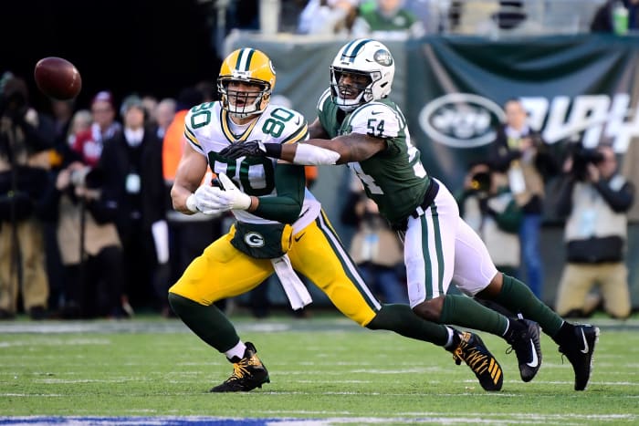 Jimmy Graham catching a pass with a defender draped all over him.