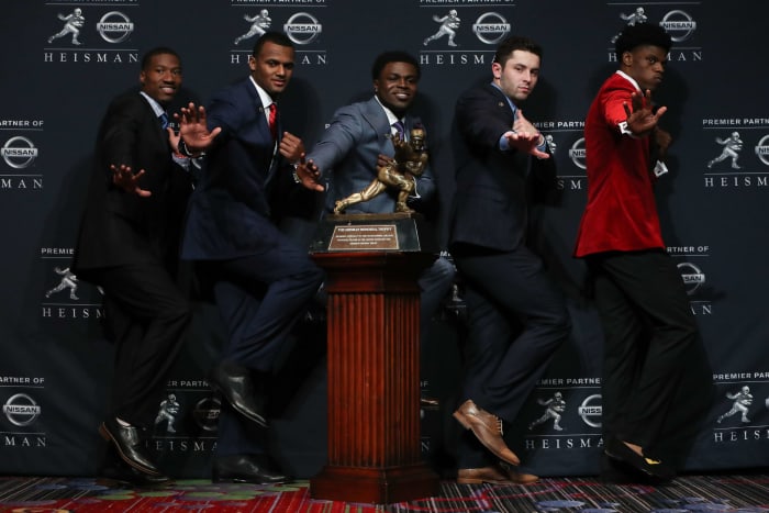 Dede Westbrook of the Oklahoma Sooners, Deshaun Watson of the Clemson Tigers, Jabrill Peppers of the Michigan Wolverines, Baker Mayfield of the Oklahoma Sooners and Lamar Jackson of the Louisville Cardinals pose for a photo with the Heisman trophy during a press conference prior to the 2016 Heisman Trophy Presentation.