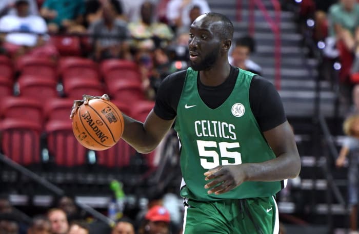 Boston Celtics center Tacko Fall takes the ball up the floor.