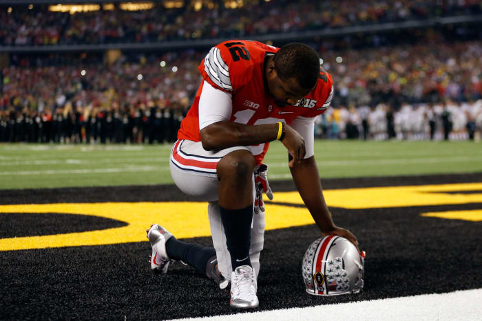 Cardale Jones kneeling in the end zone before a game.