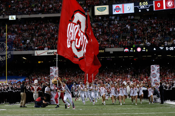 Ohio State cheerleaders running onto the field.