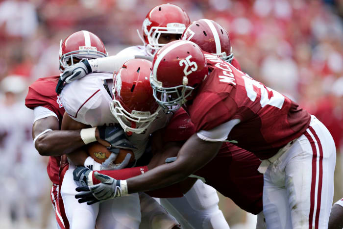 Alabama players, including Rolando McClain, make a tackle on an Arkansas runner.