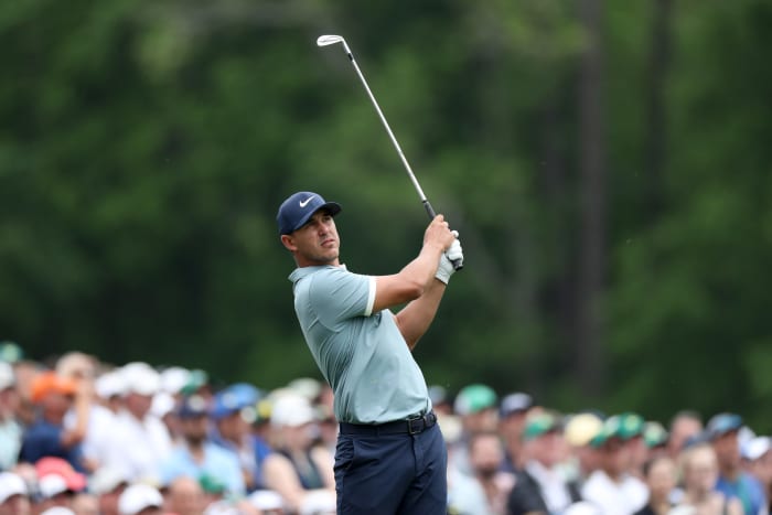 Brooks Koepka hitting a golf ball.