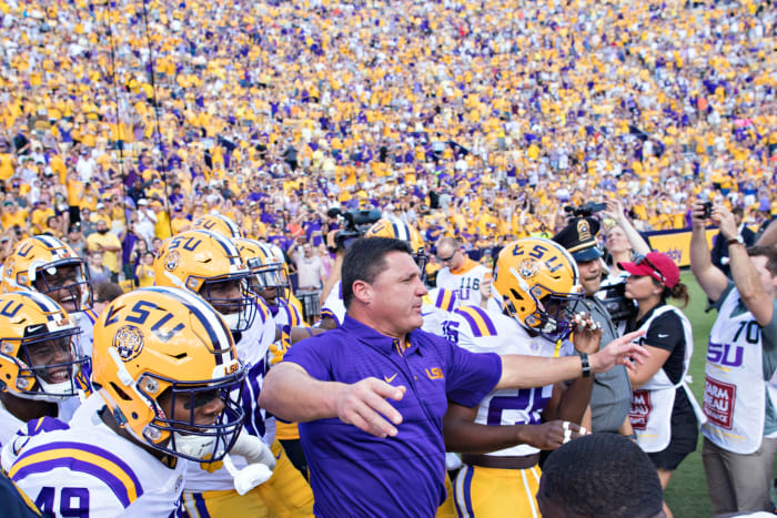 LSU head coach Ed Orgeron leads his team onto the field.