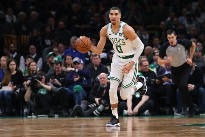 Jayson tatum takes the ball up the floor.