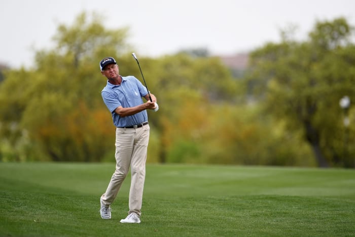 Davis Love III reacts to his shot.