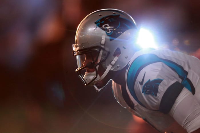 Cam Newton crouching over.