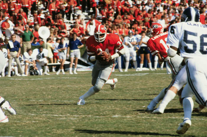 Georgia legend Herschel Walker runs the ball.