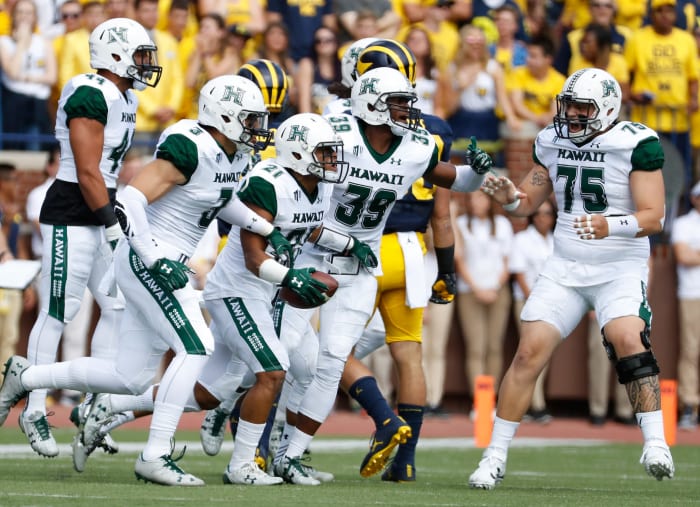 Hawaii football celebrates interception at Michigan.