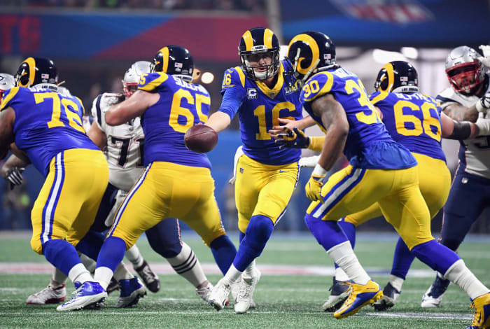 the los angeles rams rush the ball against the patriots