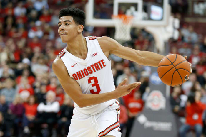 Ohio State point guard D.J. Carton throws a pass in a game.