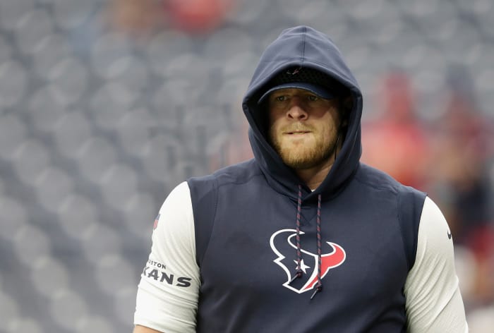 J.J. Watt wearing a hoodie and a hat before a game.