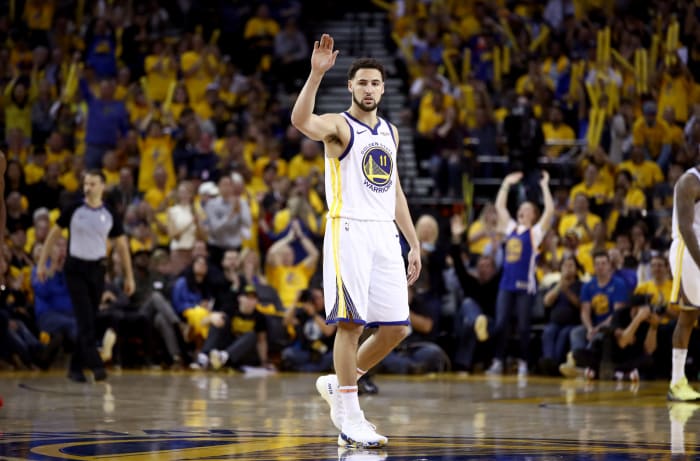 Klay Thompson waving to fans.