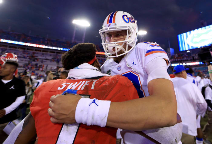 Feleipe Franks and D'Andre Swift hugging after a game.