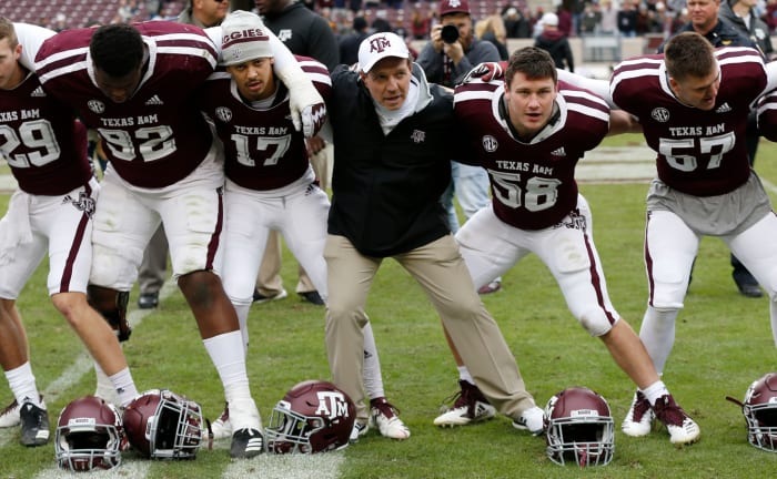 Jimbo Fisher interacting with his players before a game.