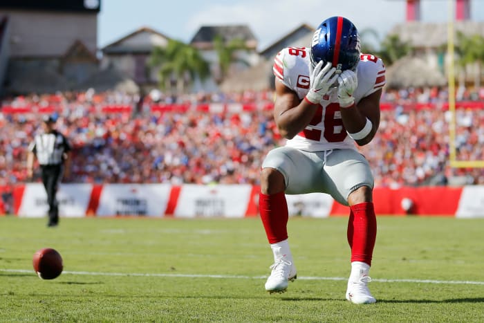 Saquon Barkley has his head in his hands after failing to catch a pass.