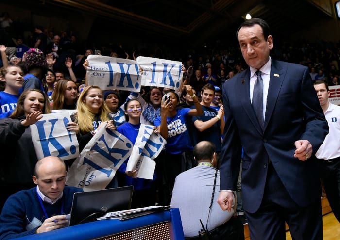 Coach K walks onto the court.