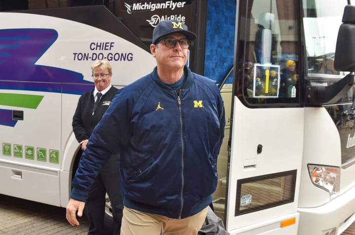 Jim Harbaugh walks off the bus before Michigan's game vs. Ohio State.