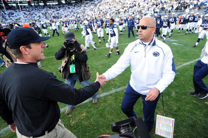 Jim Harbaugh and James Franklin shaking hands after a football game.