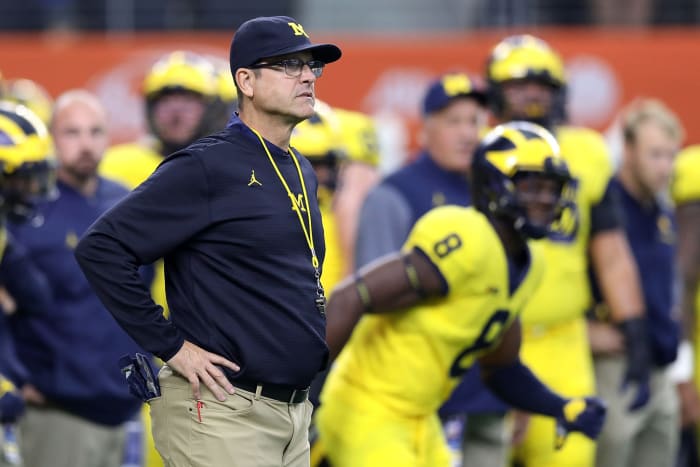 Head coach Jim Harbaugh of the Michigan Wolverines looks on during warmups before the college football game against the Florida Gators.