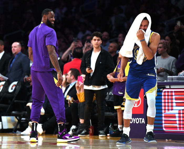 LeBron James cracks a joke with Steph Curry.