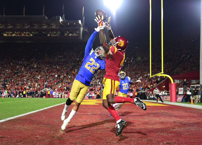 UCLA defender looks to break up a pass to USC wide receiver in the major Pac-12 football rivalry game.