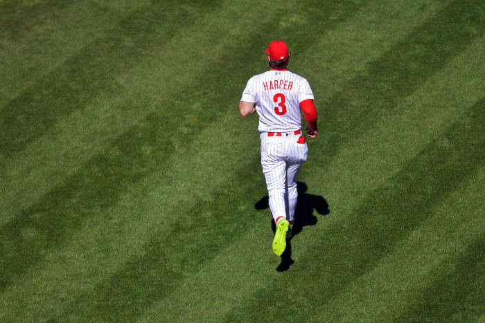 bryce harper makes his way onto the field for the phillies