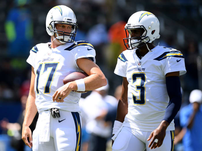 Philip Rivers talks to Geno Smith before a game.