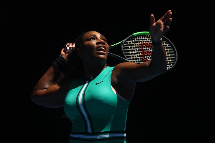 Serena Williams serving the tennis ball.