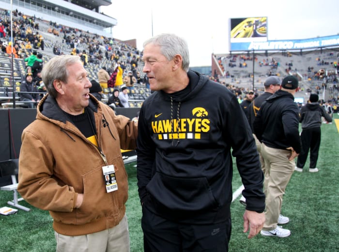 Iowa president Bruce Harreld walks with Kirk Ferentz.