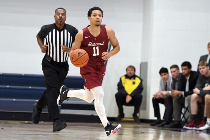 Harvard point guard Bryce Aiken dribbles the ball.