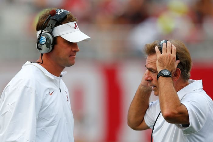 Nick Saban talking to Lane Kiffin on Alabama's sideline.