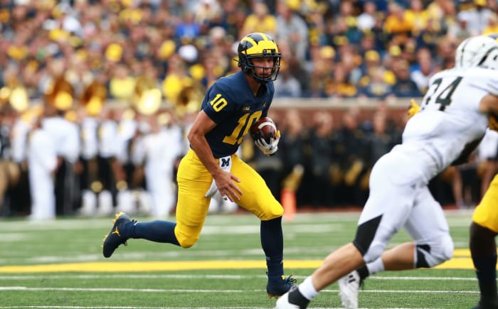 Dylan McCaffrey runs the football for Michigan Wolverines.