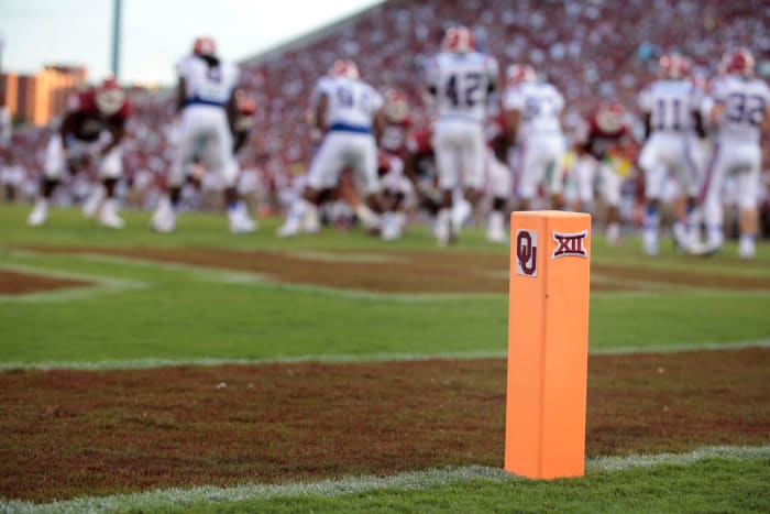 A closeup of a football pylon with Oklahoma's logo on it.