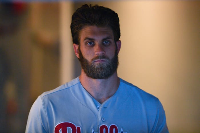 A closeup of Bryce Harper in the dugout.