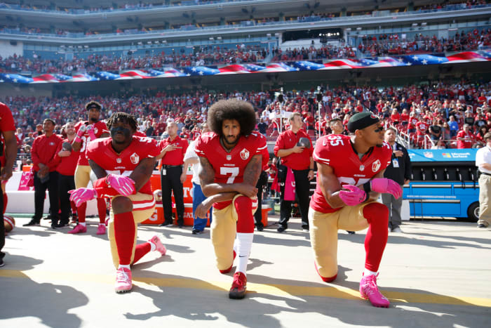 Colin Kaepernick takes a knee before a game.