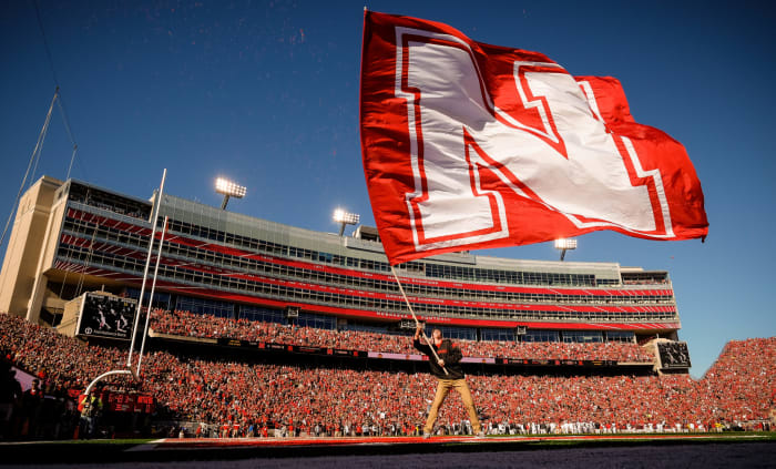 Nebraska flag bearer waves massive Nebraska flag.
