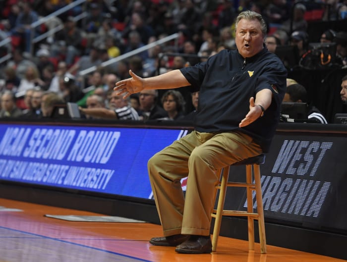 Bob Huggins sitting on a stool.