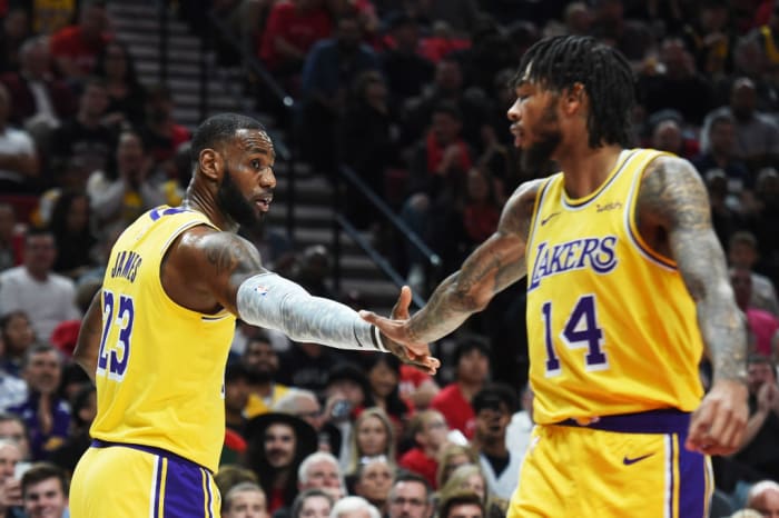 lebron james and brandon ingram high five during a game