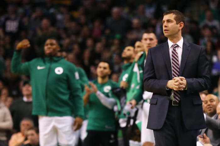 Brad Stevens clasping his hands on the Celtics bench.