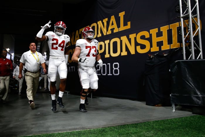 Alabama players Brian Robinson and Jonah Williams walking onto the field.